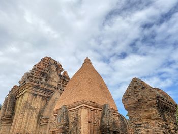 Low angle view of temple against cloudy sky