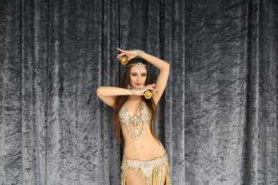 Portrait of woman standing against wall