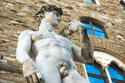 Low angle view of david statue against historic building