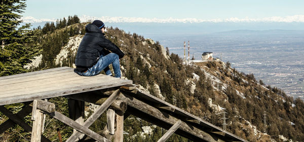 Man sitting against landscape