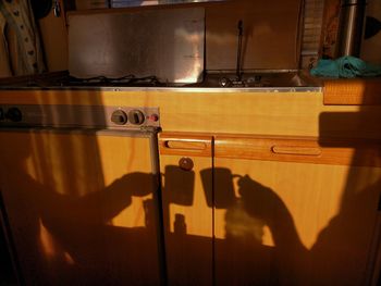 Shadow of man holding metal at home