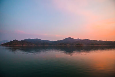 Scenic view of lake against romantic sky at sunset