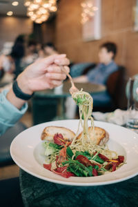 Midsection of man having food in restaurant