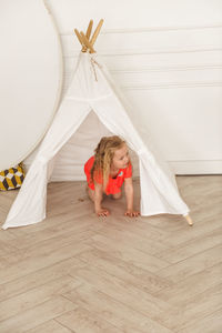 Girl playing in a tent