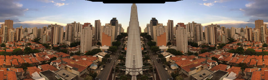 Aerial view of buildings in city against sky