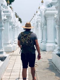 Rear view of man standing outside temple