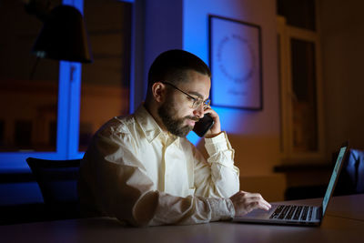 Young businessman, employee prepare for business presentation or financial report call to colleague