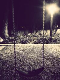 Close-up of swing at night