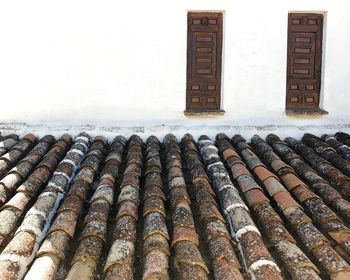 Stack of old roof tiles on building