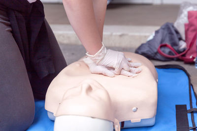 Volunteer giving first aid training with mannequin