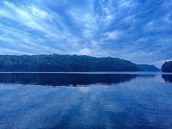 Scenic view of lake against cloudy sky