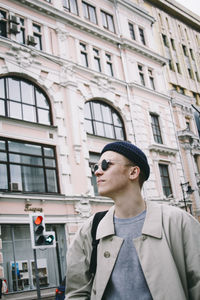 Portrait of man standing in front of building