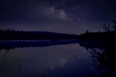 Scenic view of lake against star field at night