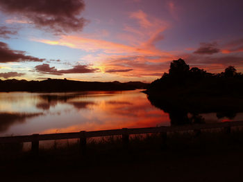 Scenic view of lake against romantic sky at sunset