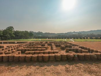 Built structure on landscape against the sky