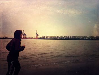 Silhouette of woman standing on beach