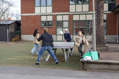 Group of teenagers playing table ball game