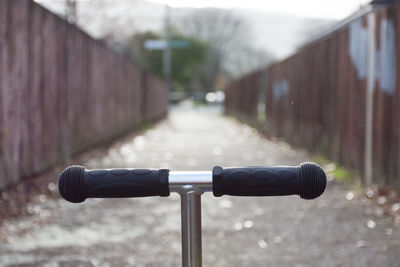 Close-up of bicycle parked on railing