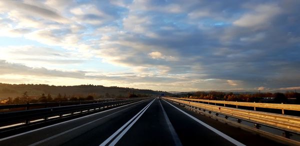 Highway against sky during sunset