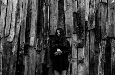 Portrait of woman standing on wood