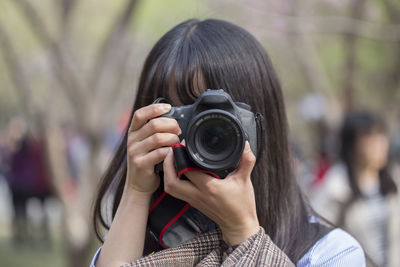 Woman photographing outdoors