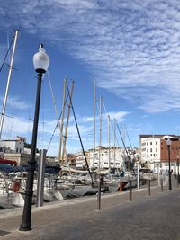 Sailboats moored at harbor