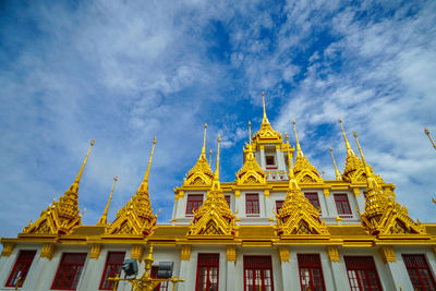 Low angle view of temple against cloudy sky