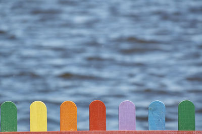 Close-up of multi colored pencils by sea