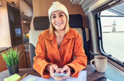 Woman talking on videoconference from her campervan