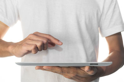 Midsection of man holding hands against white background