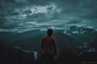 Rear view of man standing on mountain