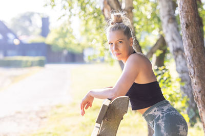 Side view of young woman exercising in park