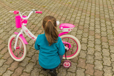 Rear view of woman with bicycle