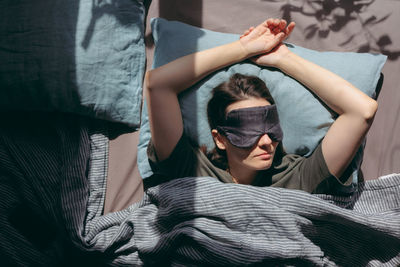 Low angle view of woman with arms raised