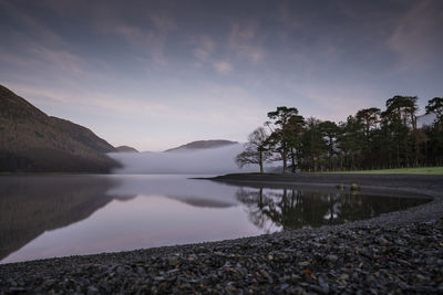 Scenic view of lake against sky during sunset