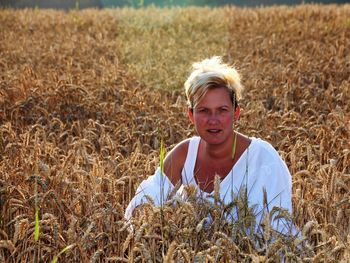 Portrait of smiling young woman in field