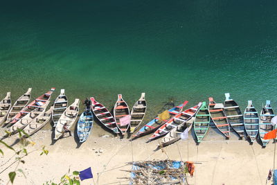 High angle view of boats moored on shore