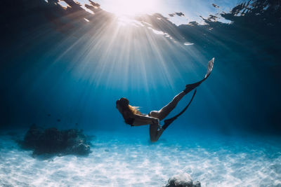 Low section of woman swimming in sea