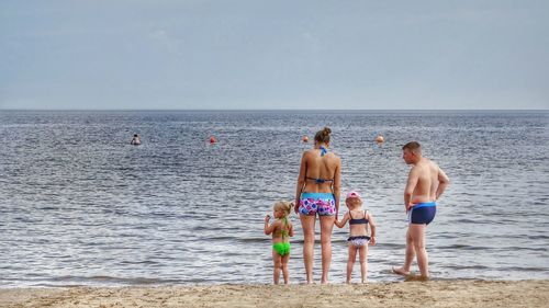 Rear view of man standing on beach