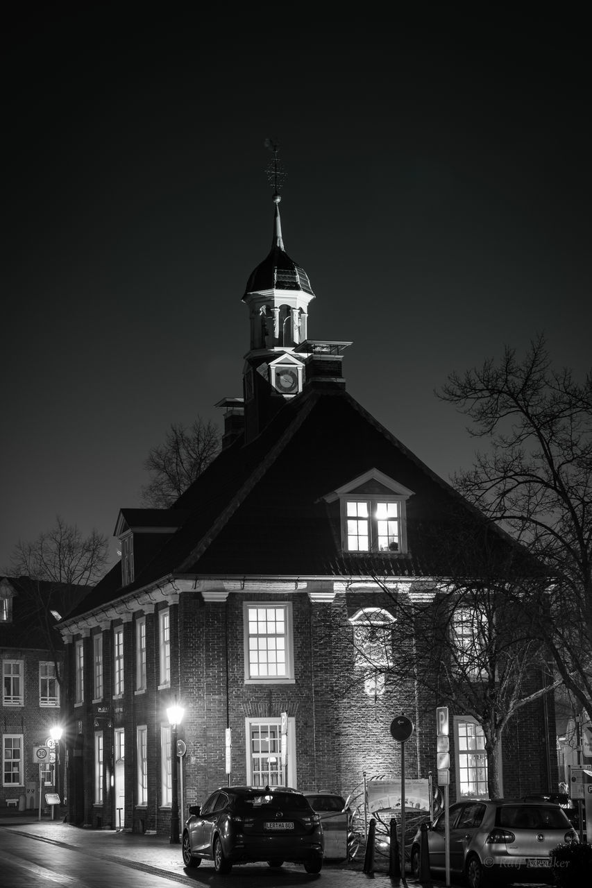 LOW ANGLE VIEW OF CLOCK TOWER AT NIGHT