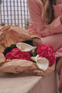 Midsection of woman holding bouquet