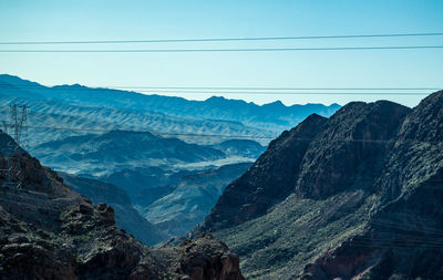 Scenic view of rocky mountains against sky on sunny day