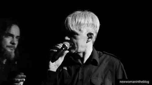 Portrait of man photographing against black background