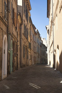 Narrow street amidst buildings in city