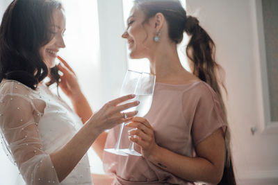 Midsection of women drinking from glass