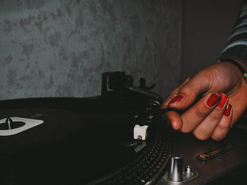 Close-up of hand playing old records