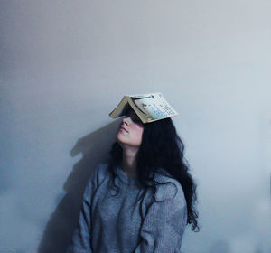 Woman looking away while sitting on floor
