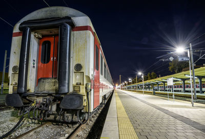 Train on railroad station platform at night