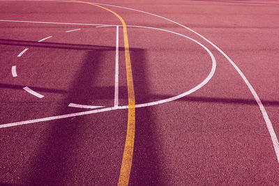 Silhouette on the red street basket court