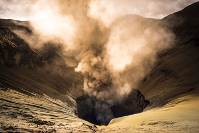 Smoke erupting from volcanic crater